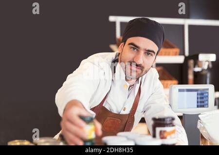 Portrait of confident male owner working in grocery store Stock Photo