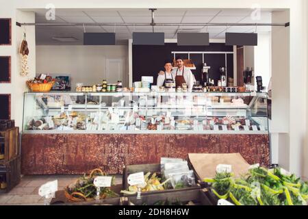 Portrait of confident owners standing in grocery store Stock Photo