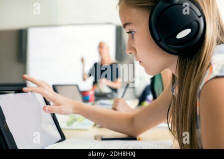 Side view of girl using digital tablet at school Stock Photo