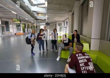 University students talking in a corridor at the University of Giessen , Biomedizinisches Forschungszentrum. Stock Photo