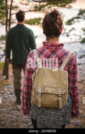 Rear view of couple hiking in forest Stock Photo