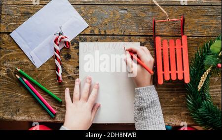 Boy writing Dear Santa letter Stock Photo