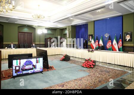 Tehran, Iran. 10th Dec, 2020. A handout photo made available by the official website of the Iranian presidential office shows Iranian President Hassan Rouhani attending via a video link the inauguration of the Herat-Khaf railway operations linking Iran and Afghanistan, in Tehran, Iran, 10 December 2020. The Herat-Khaf railway, officially opened on 10 December, is 130kms long track connecting Iran's eastern city of Khaf to Afghanistan's western Herat province, providing a crucial transport link for the landlocked Afghanistan. Credit: Iranian Presidency/ZUMA Wire/Alamy Live News Stock Photo