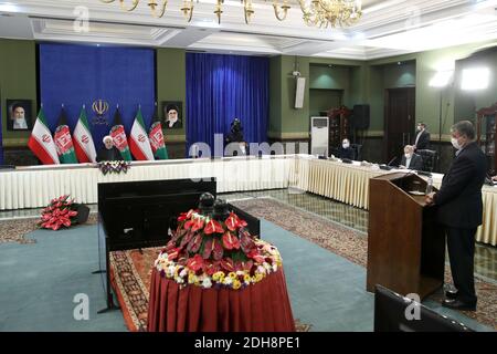 Tehran, Iran. 10th Dec, 2020. A handout photo made available by the official website of the Iranian presidential office shows Iranian President Hassan Rouhani attending via a video link the inauguration of the Herat-Khaf railway operations linking Iran and Afghanistan, in Tehran, Iran, 10 December 2020. The Herat-Khaf railway, officially opened on 10 December, is 130kms long track connecting Iran's eastern city of Khaf to Afghanistan's western Herat province, providing a crucial transport link for the landlocked Afghanistan. Credit: Iranian Presidency/ZUMA Wire/Alamy Live News Stock Photo