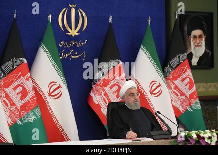 Tehran, Iran. 10th Dec, 2020. A handout photo made available by the official website of the Iranian presidential office shows Iranian President Hassan Rouhani attending via a video link the inauguration of the Herat-Khaf railway operations linking Iran and Afghanistan, in Tehran, Iran, 10 December 2020. The Herat-Khaf railway, officially opened on 10 December, is 130kms long track connecting Iran's eastern city of Khaf to Afghanistan's western Herat province, providing a crucial transport link for the landlocked Afghanistan. Credit: Iranian Presidency/ZUMA Wire/Alamy Live News Stock Photo