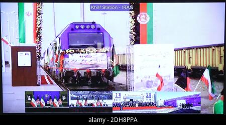Tehran, Iran. 10th Dec, 2020. A handout photo made available by the official website of the Iranian presidential office of a screen showing the inaugurate ceremony of the Herat-Khaf railway operations linking Iran and Afghanistan, in Tehran, Iran, 10 December 2020. The Herat-Khaf railway, officially opened on 10 December, is 130kms long track connecting Iran's eastern city of Khaf to Afghanistan's western Herat province, providing a crucial transport link for the landlocked Afghanistan. Credit: Iranian Presidency/ZUMA Wire/Alamy Live News Stock Photo