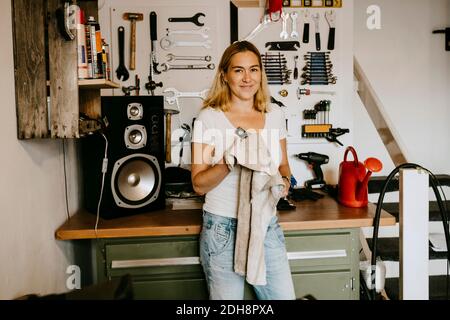 Portrait of confident female owner standing in bicycle shop Stock Photo