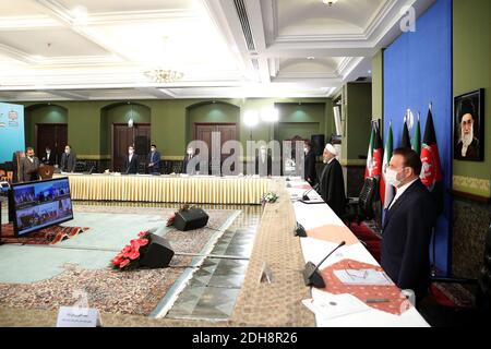 Tehran, Iran. 10th Dec, 2020. In this photo released by the official website of the office of the Iranian Presidency, President Hassan Rouhani stands at the start of a video conference with his Afghan counterpart to inaugurate the first railway link between the two countries, at the presidency palace in Tehran, Iran, Thursday, Dec. 10, 2020. The 140-kilometer (90-mile) line running from eastern Iran into western Afghanistan will eventually be expanded to reach the Afghan city of Herat, providing a crucial transport link for the landlocked country. (Credit Image: © Iranian Presidency via ZUM Stock Photo