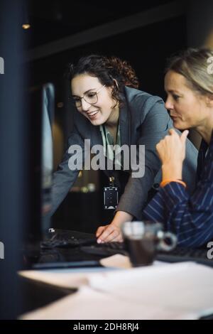 Smiling female IT professionals working on computer in office Stock Photo