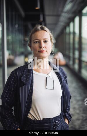 Portrait of confident businesswoman standing in creative office Stock Photo
