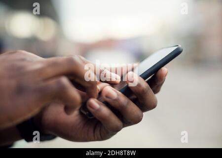 Cropped image of man using smart phone Stock Photo
