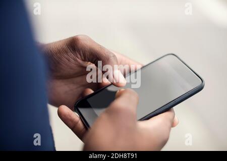 Cropped image of man using mobile phone Stock Photo
