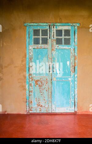 Vintage style old house door and window. Vintage building and old aged design. Grunge old colorful paint. Stock Photo