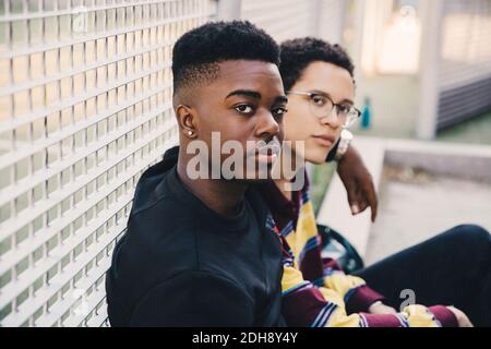 Portrait of young men sitting against net Stock Photo