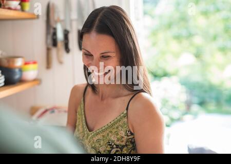 Cheerful woman in kitchen at home Stock Photo