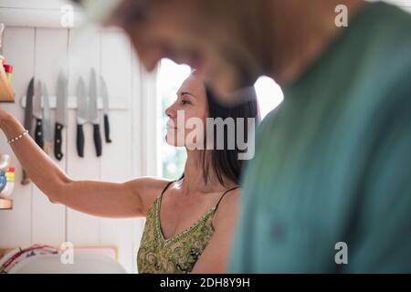 Mature couple working in kitchen at home Stock Photo