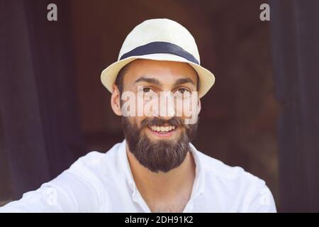 Portrait of smiling man wearing fedora hat Stock Photo