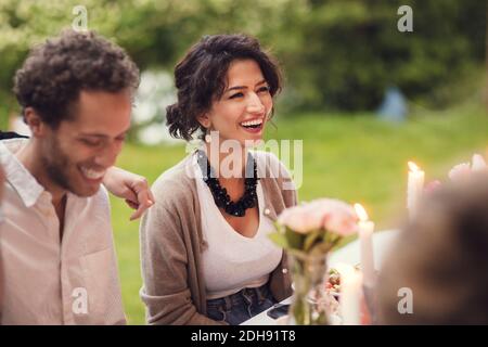 Happy friends sitting at table during garden party Stock Photo