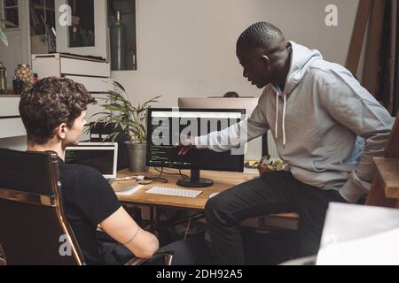 Computer programmers working on coding at workplace Stock Photo