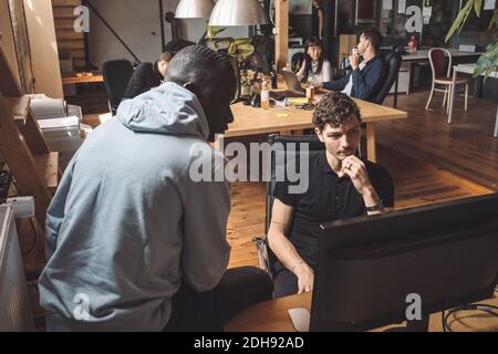 Computer programmers working on computer at place of work Stock Photo
