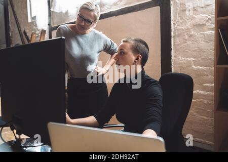 Businesswomen working on computer at workplace Stock Photo