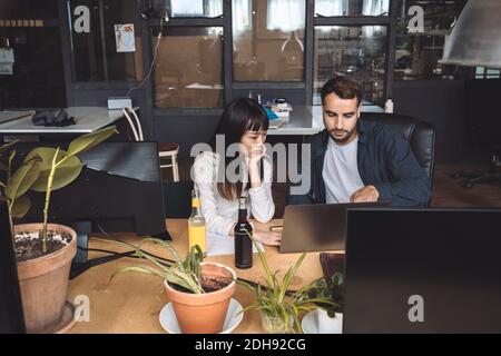 High angle view of colleagues discussing at workplace Stock Photo