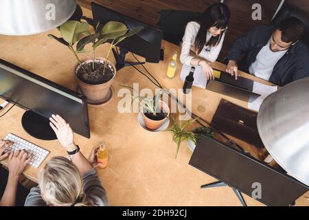 High angle view of coworkers discussing at workplace Stock Photo