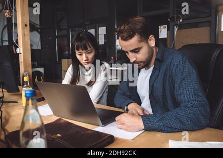 Entrepreneur and female colleague coworking at workplace Stock Photo