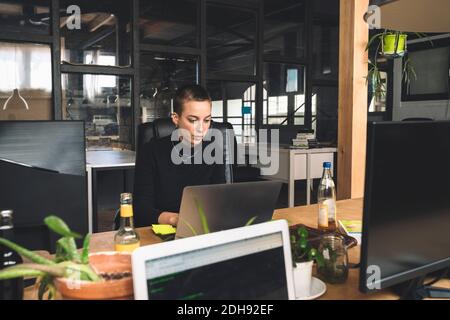 Businesswoman working over laptop at workplace Stock Photo