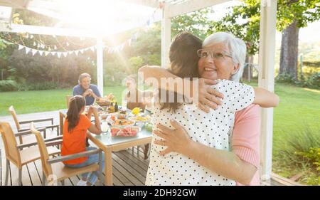 Family eating outside together in summer Stock Photo