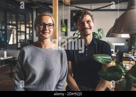 Portrait of smiling computer programmers at workplace Stock Photo