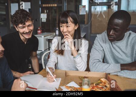 Smiling business partners working at workplace Stock Photo