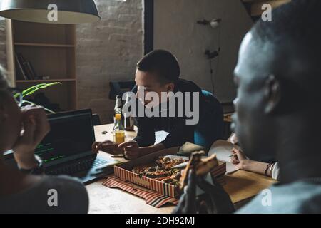 Young computer programmer using laptop at workplace Stock Photo