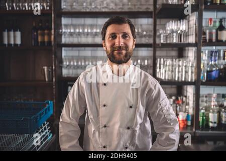 Portrait of smiling chef in commercial kitchen Stock Photo