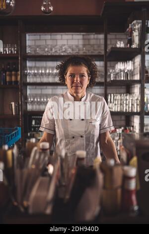 Portrait of female chef in commercial kitchen Stock Photo