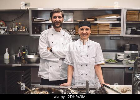 Portrait of smiling chefs in commercial kitchen Stock Photo