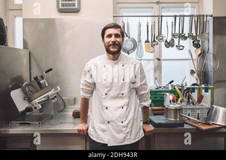 Portrait of confident chef standing in commercial kitchen Stock Photo