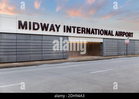 The exterior of the Midway International Airport sign at the departures entrance during sunset. Stock Photo