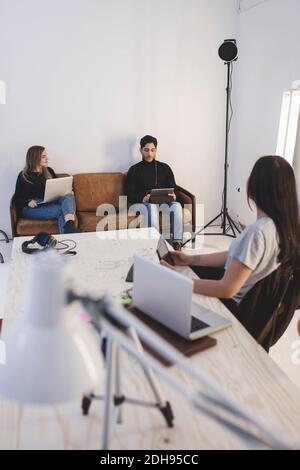 Three colleagues discussing in creative office Stock Photo