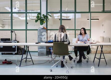 Two women working at desk in creative office Stock Photo