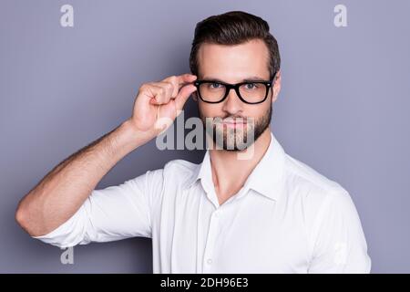 Close-up portrait of his he nice attractive successful content serious professional man ceo boss chief wearing touching specs focus isolated over grey Stock Photo