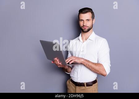 Portrait of his he nice attractive focused skilled brunet guy employer using laptop researching analyzing web market browsing finance report isolated Stock Photo