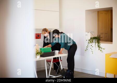 Mid adult businesswoman having discussion at table in office Stock Photo