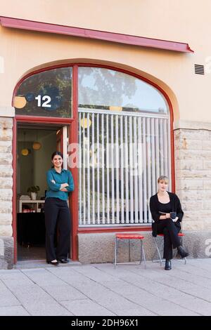 Full length portrait of confident businesswomen outside office Stock Photo