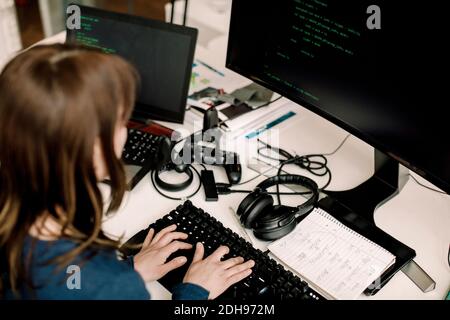 Female entrepreneur working on programming at workplace Stock Photo