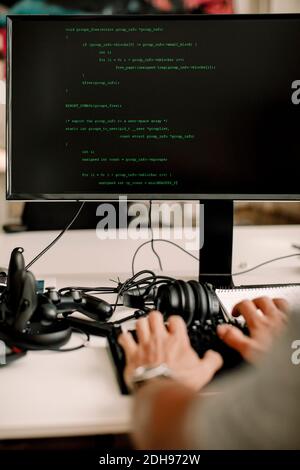 Cropped hands of entrepreneur working on computer programming at workplace Stock Photo