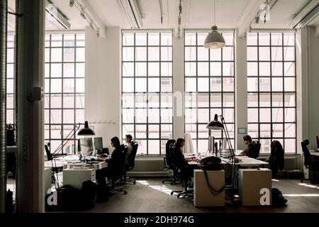 Male and female professionals working in office Stock Photo