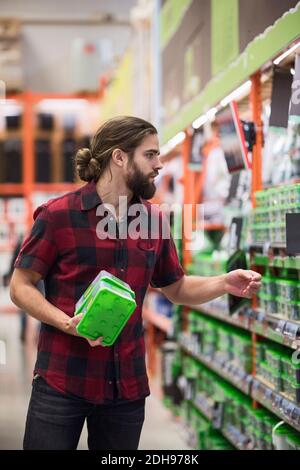 Male customer buying nail boxes in hardware store Stock Photo