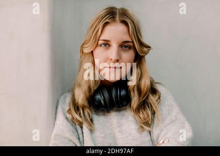 Portrait of confident businesswoman against wall in office Stock Photo