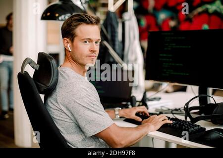 Portrait of male computer programmer working in office Stock Photo